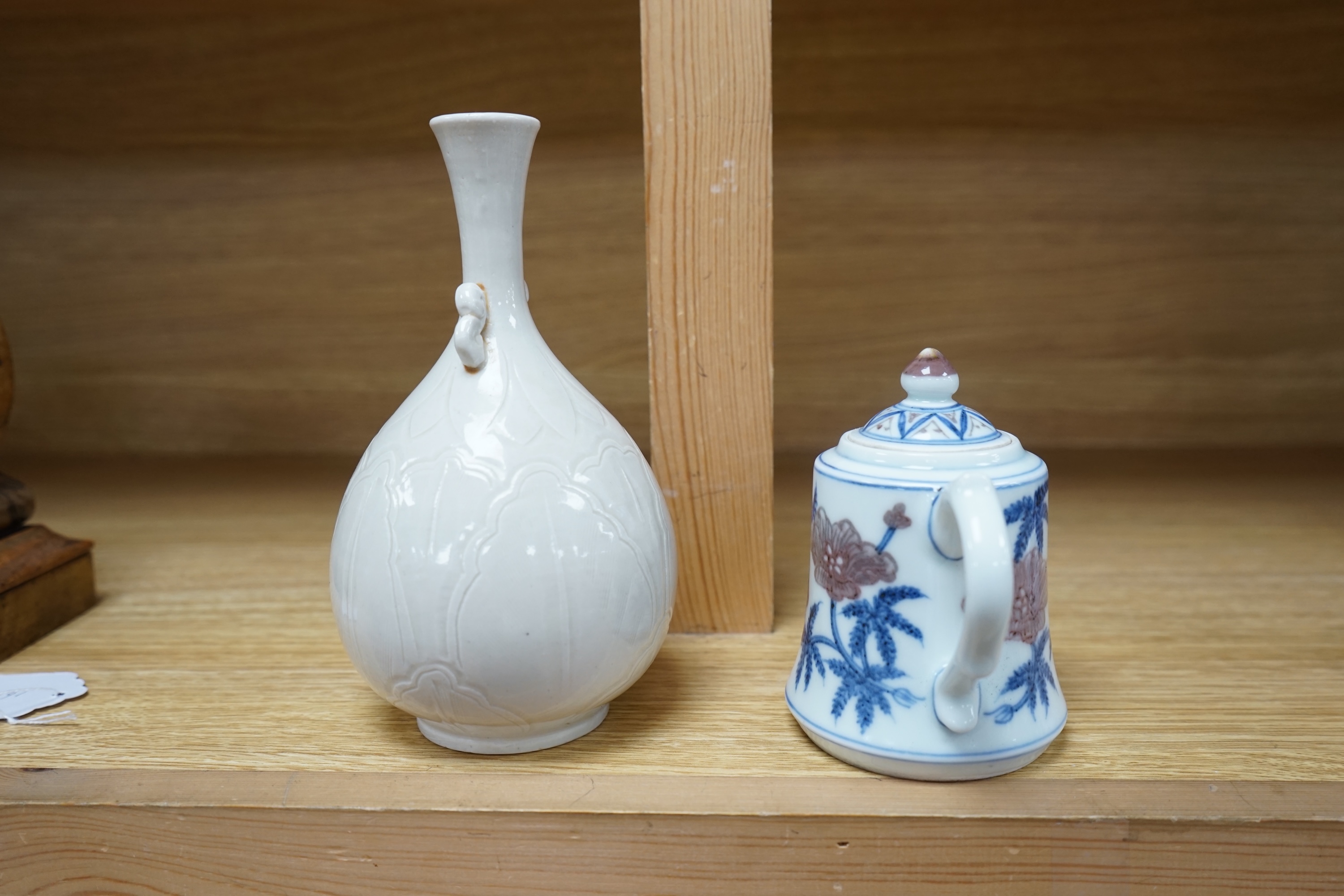 A Chinese carved bottle vase, 18cm high, and a small teapot. Condition - fair to good.